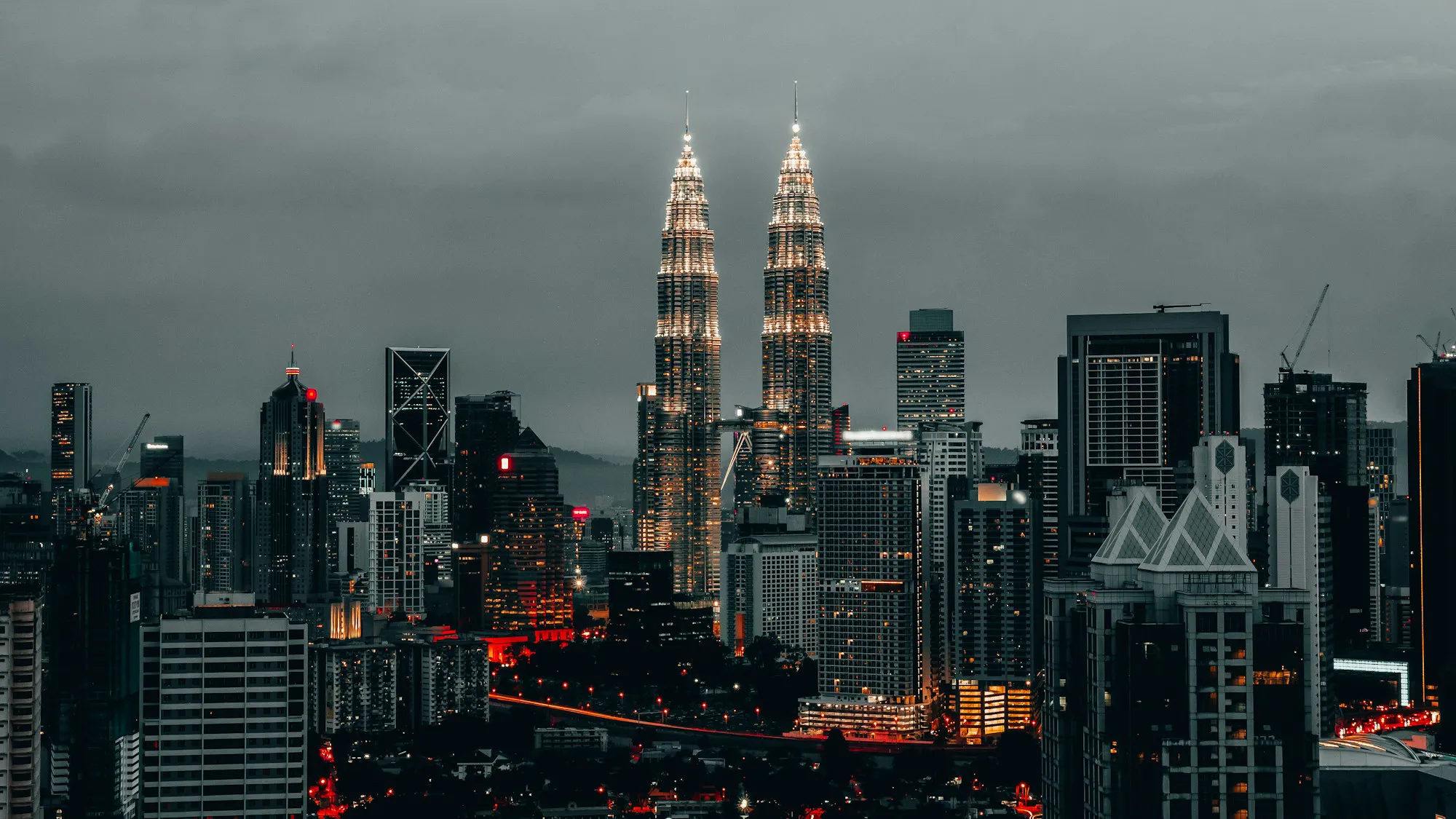 The Kuala Lumpur skyline and Petronas Twin Towers lit up at night